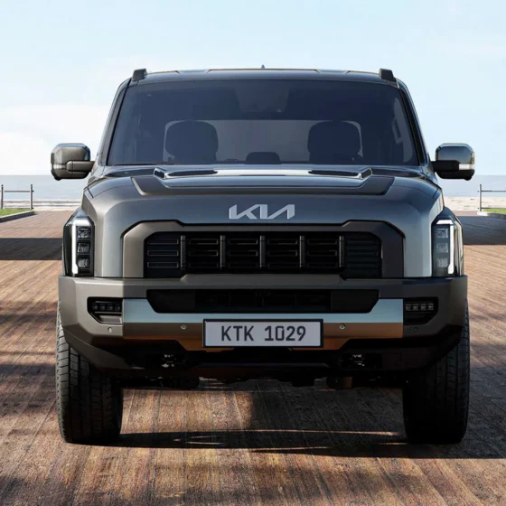 Kia Tasman front three-quarter view on an outback dirt track