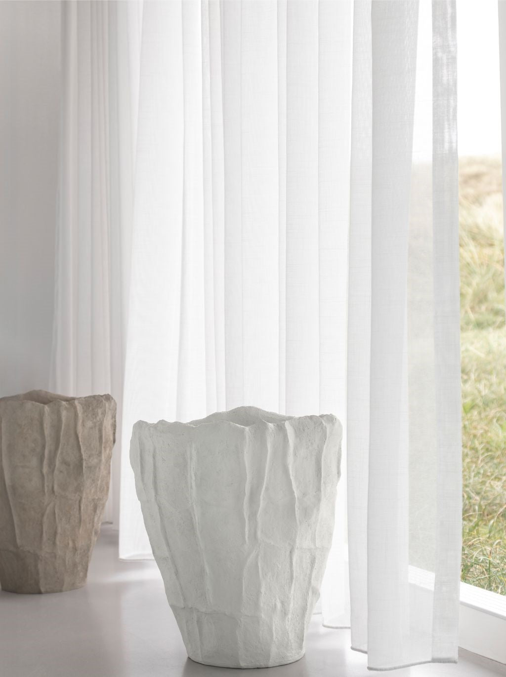 Mette Ditmer Art Piece Artistic Vase in Sand and White styled beside a window