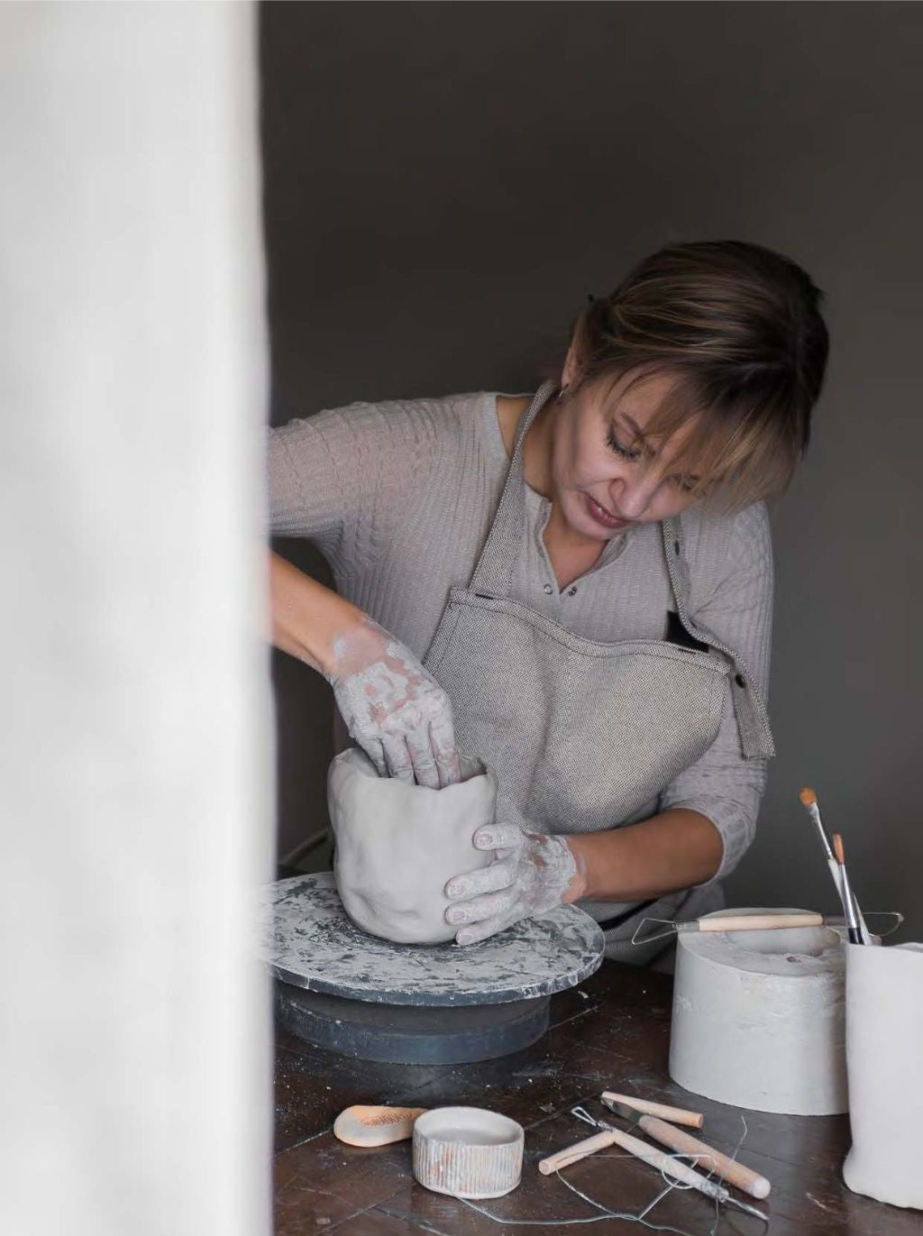Mette Ditmer hand-sculpting ceramics at the pottery wheel
